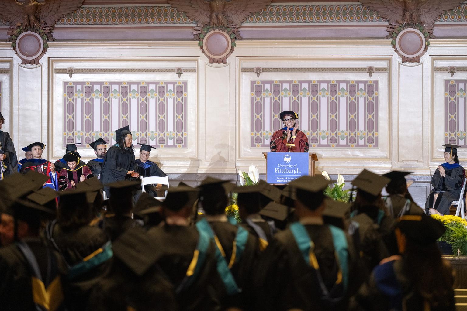 Dean Slotterback claps for this year's graduates